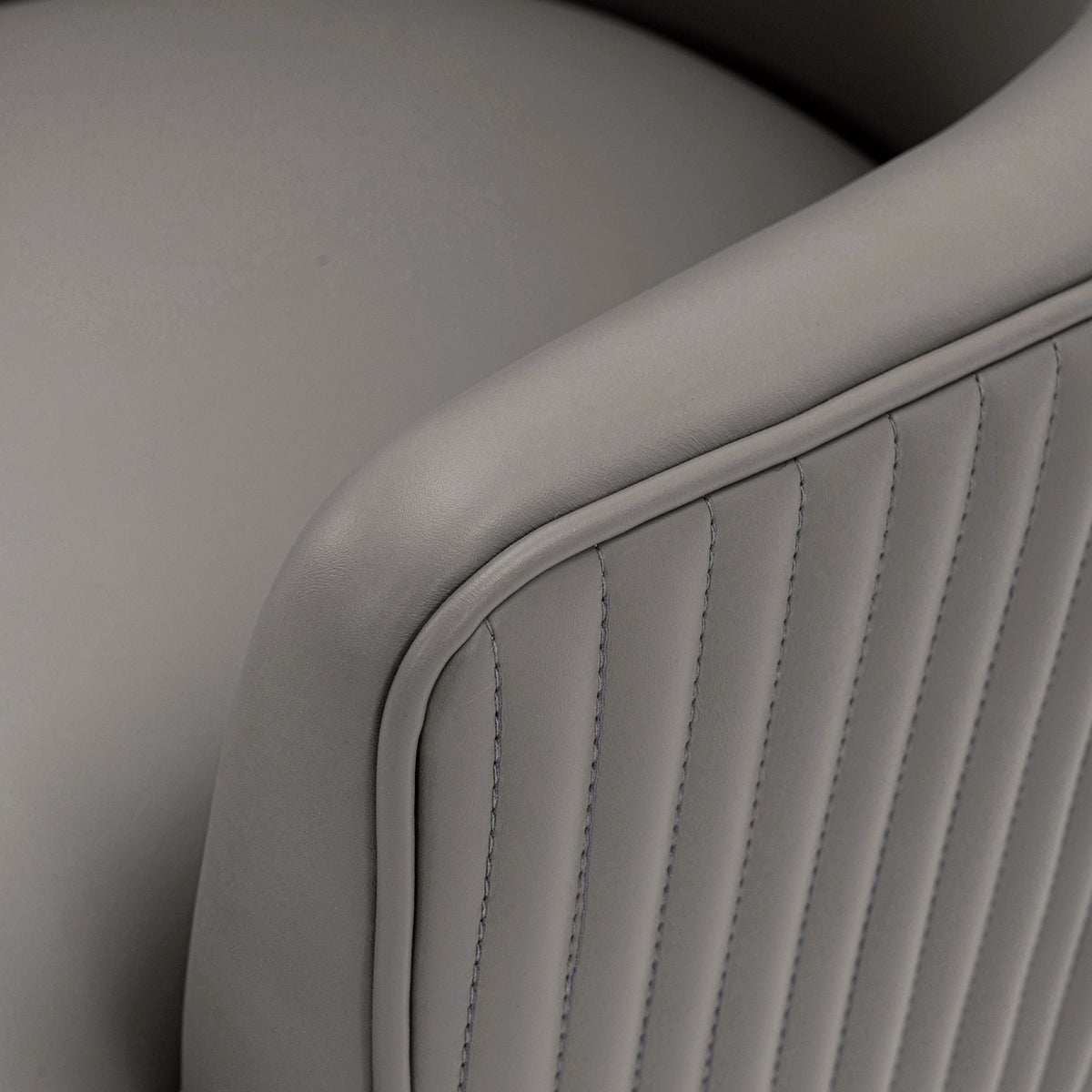 Gray faux leather dining chair close-up with channel stitching, arm chair by HouseOfZazla on Tampa Home & Garden Store