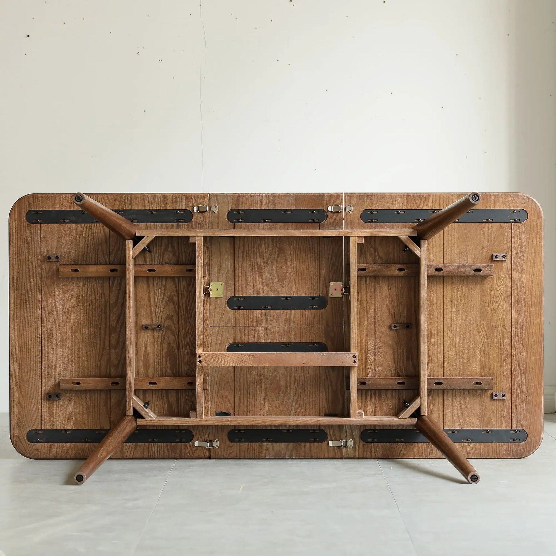 Round Corner Diagonal Leg Telescopic Dining Table underside in oak wood with metal hardware on Tampa Home & Garden Store