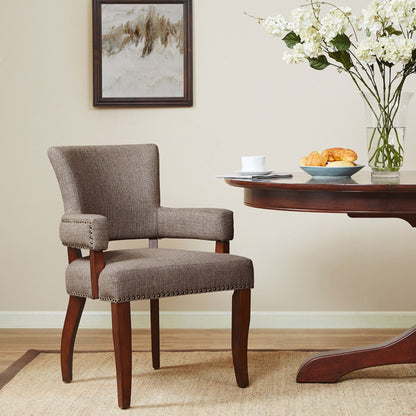 Elegant Arm Dining Chair in gray fabric with brass nailhead detailing and dark wood legs on Tampa Home & Garden Store