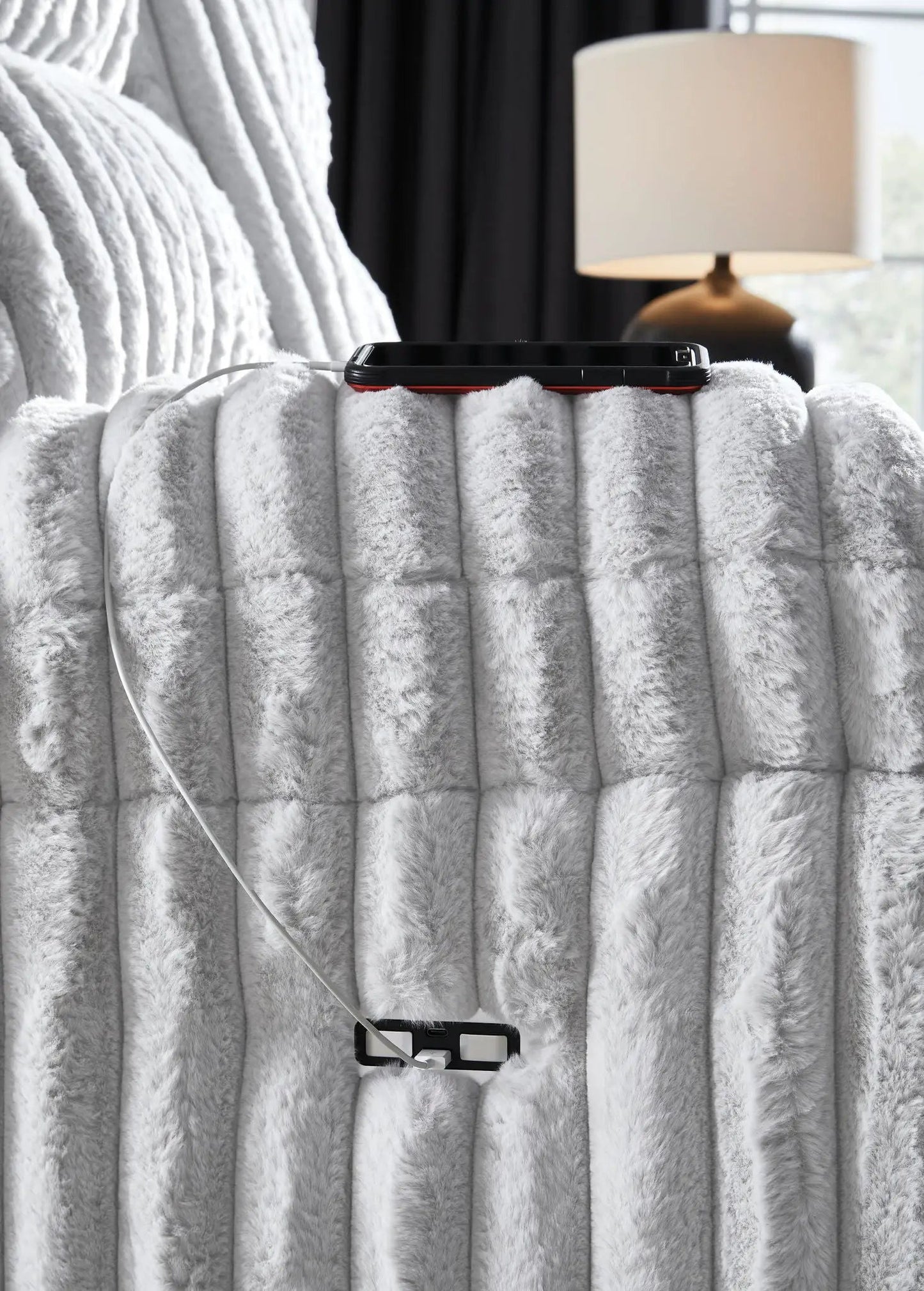 Rhines Falls Zero Wall Recliner Alloy on plush blanket with phone and charger; lamp behind on Tampa Home & Garden Store