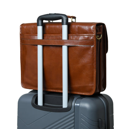The Architect Brown Executive briefcase by Classy Leather Bags atop a gray rolling suitcase on Tampa Home & Garden Store