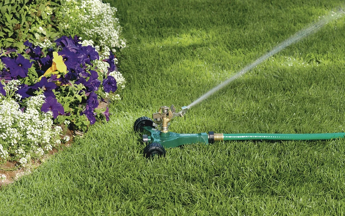 Brass impact sprinkler on metal wheel base watering lawn Orbit Irrigation large area sprinkler on Tampa Home & Garden Store