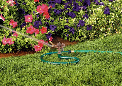 Brass impact sprinkler on metal ring base watering lawn with a green hose Orbit Irrigation on Tampa Home & Garden Store