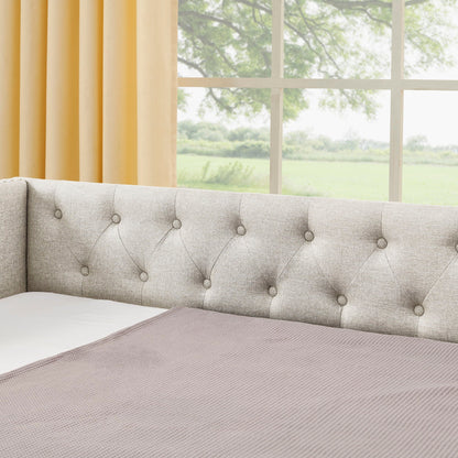 Upholstered daybed in gray fabric with diamond-tufted back and button details on Tampa Home & Garden Store