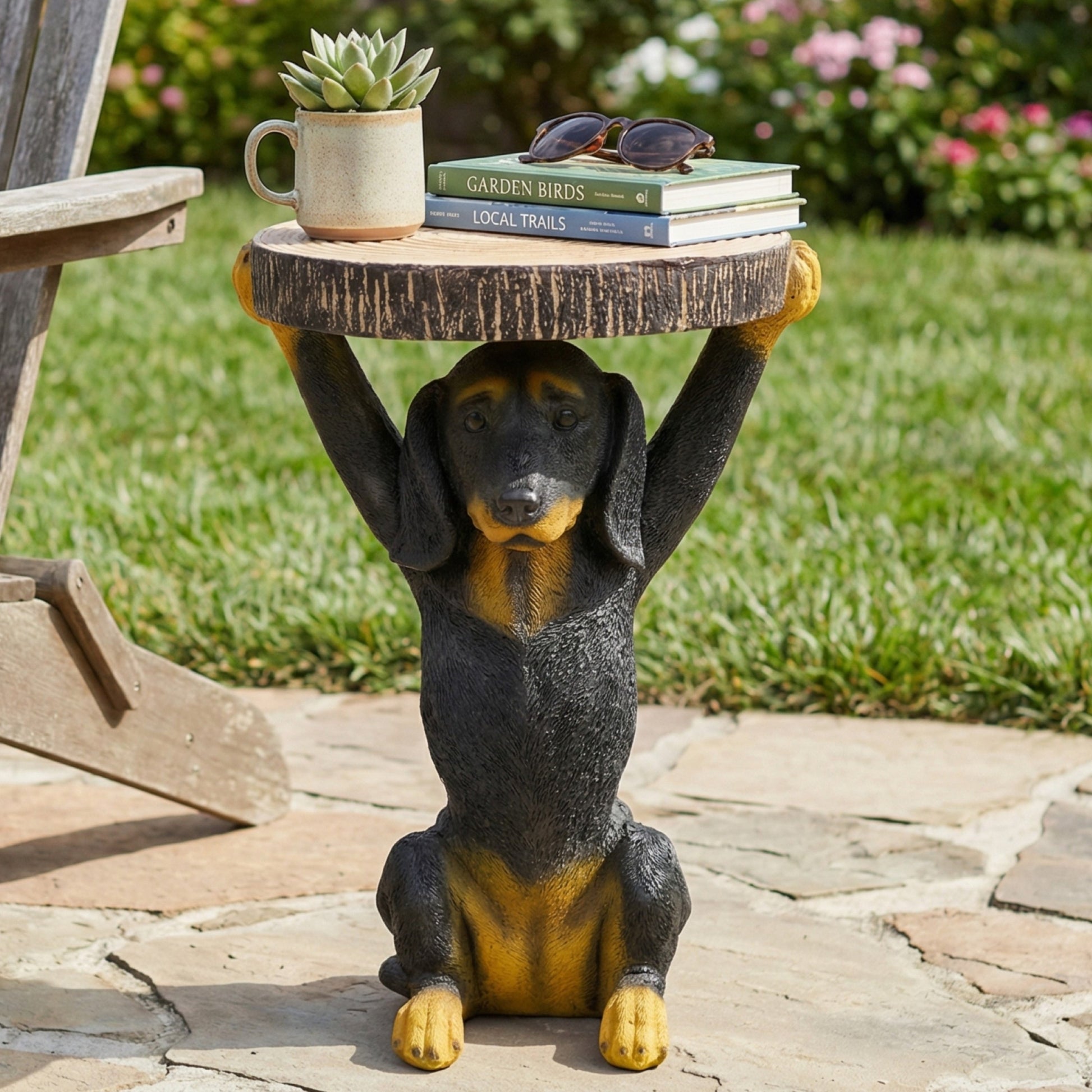 Whimsical Black Dog MGO Side Table; wood top perched on a dog statue, books and sunglasses on Tampa Home & Garden Store