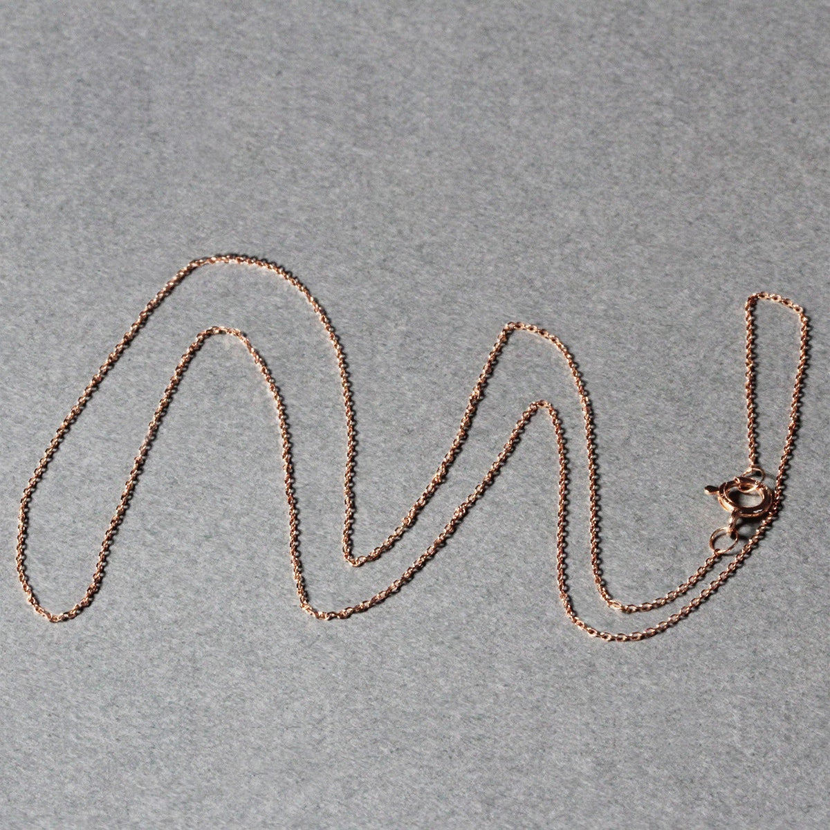14k rose gold diamond-cut cable-link chain necklace 0.7mm on gray backdrop on Tampa Home & Garden Store