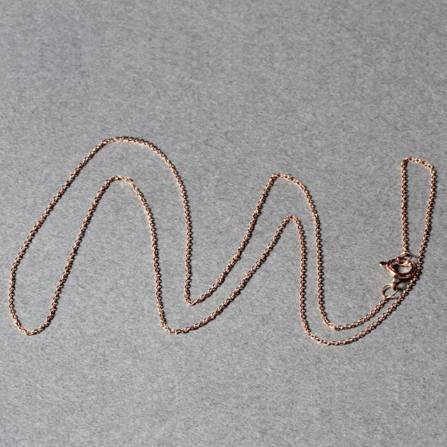 14k rose gold diamond-cut cable-link chain necklace 0.7mm on gray backdrop on Tampa Home & Garden Store