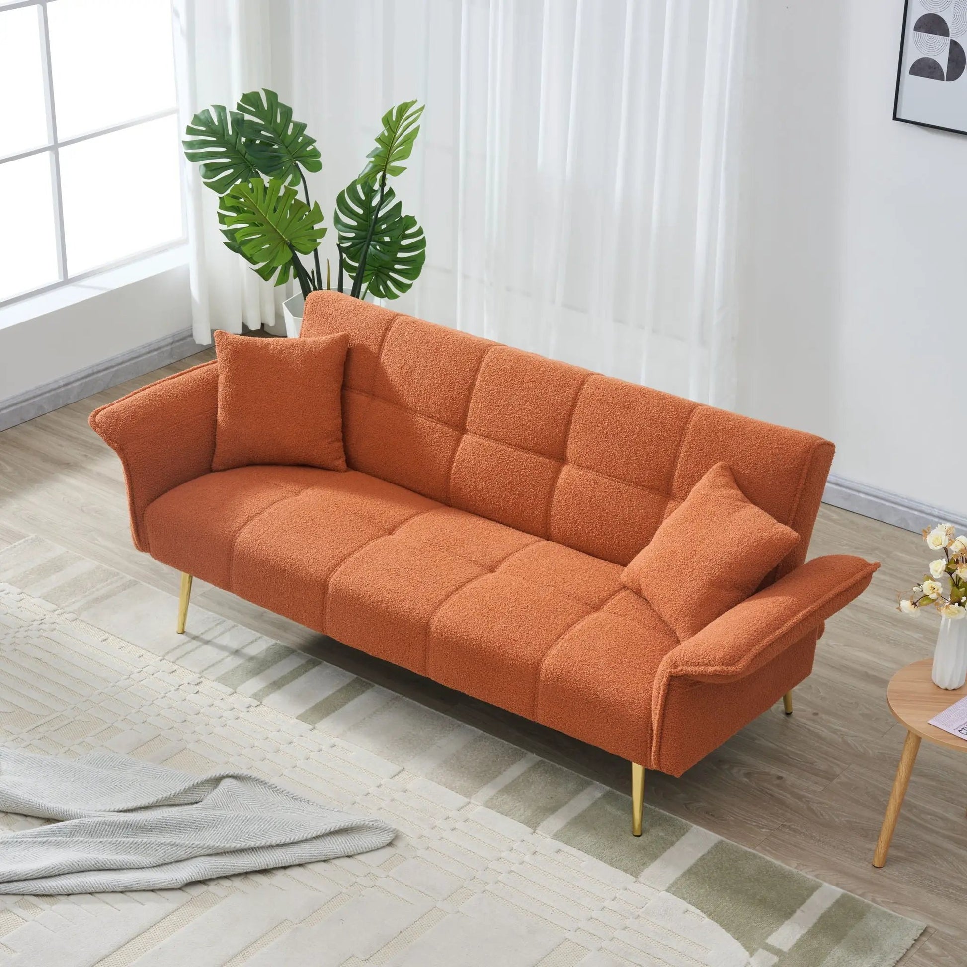 Convertible double futon sofa bed in orange textured fabric with folding armrests on Tampa Home & Garden Store