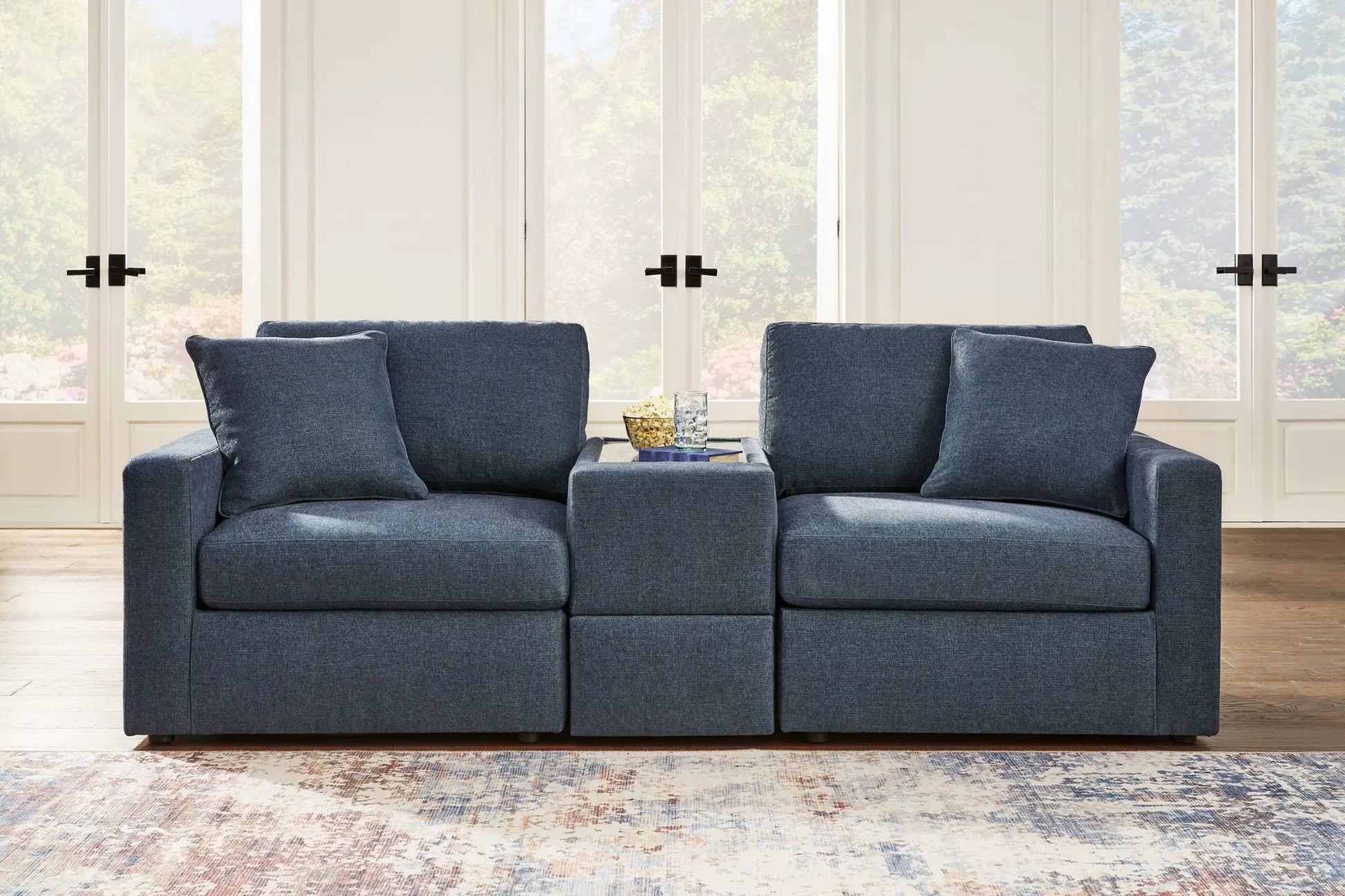 Modmax Sectional Ink blue fabric with two sofa modules and ottoman in a living room on Tampa Home & Garden Store