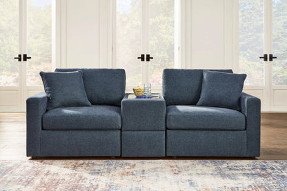 Modmax Sectional Ink blue fabric with two sofa modules and ottoman in a living room on Tampa Home & Garden Store