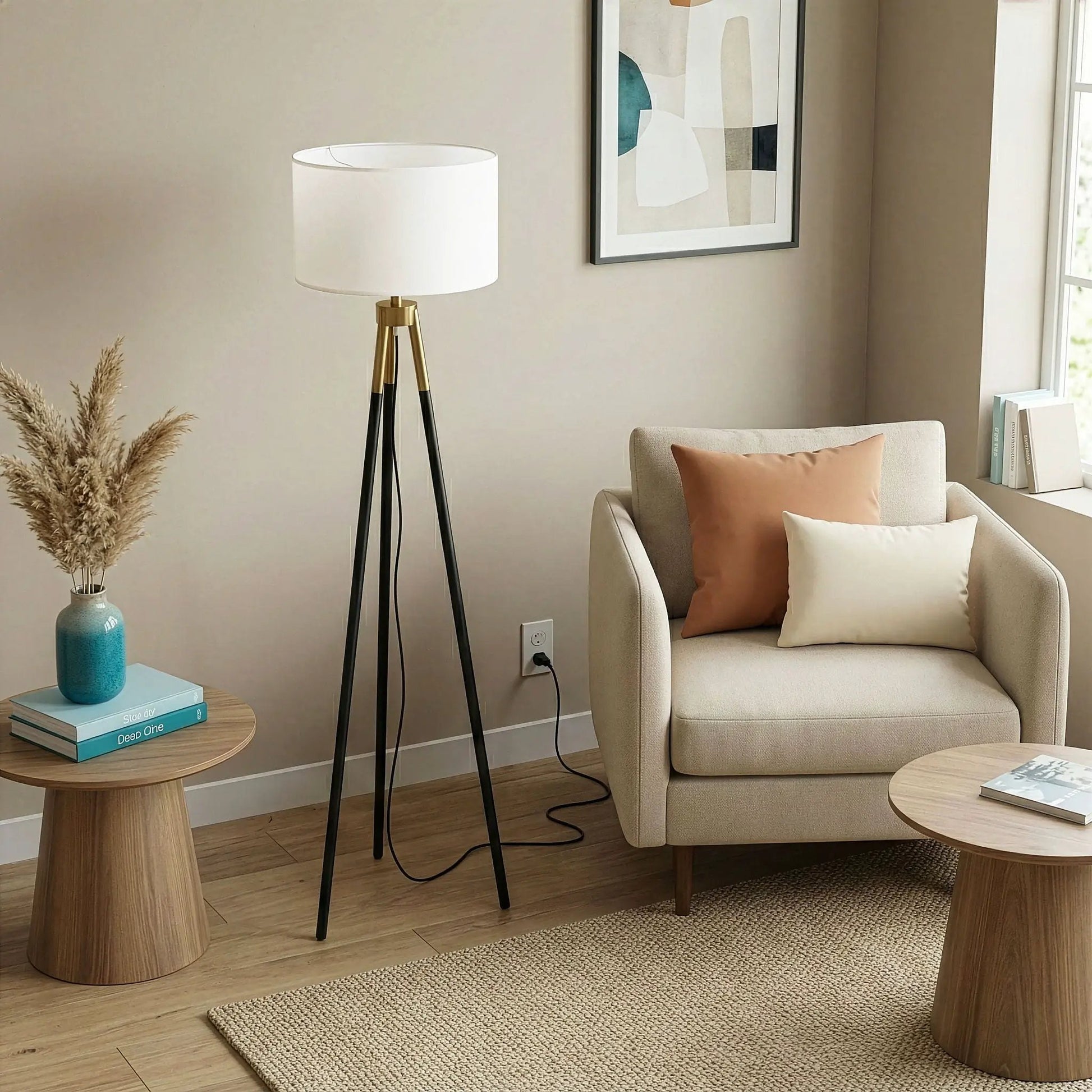 Floor lamp with three-legged black base, brass accents and white drum shade on Tampa Home & Garden Store