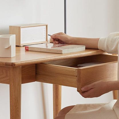 Oak Computer Desk with Drawer in natural wood finish with a hand reaching for a pencil on Tampa Home & Garden Store