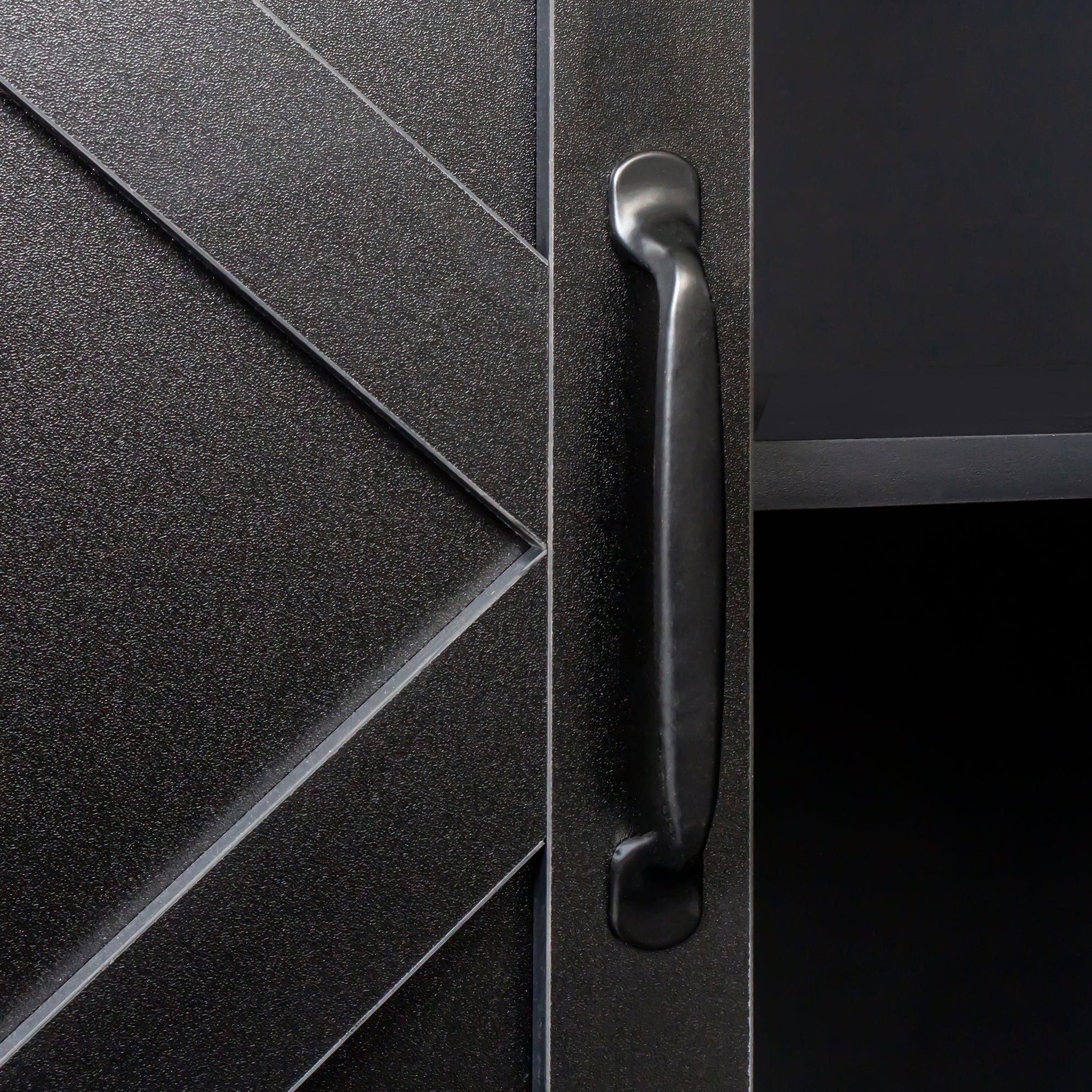 Cabinet close-up: black textured panel with a curved metal handle by HouseOfZazla on Tampa Home & Garden Store