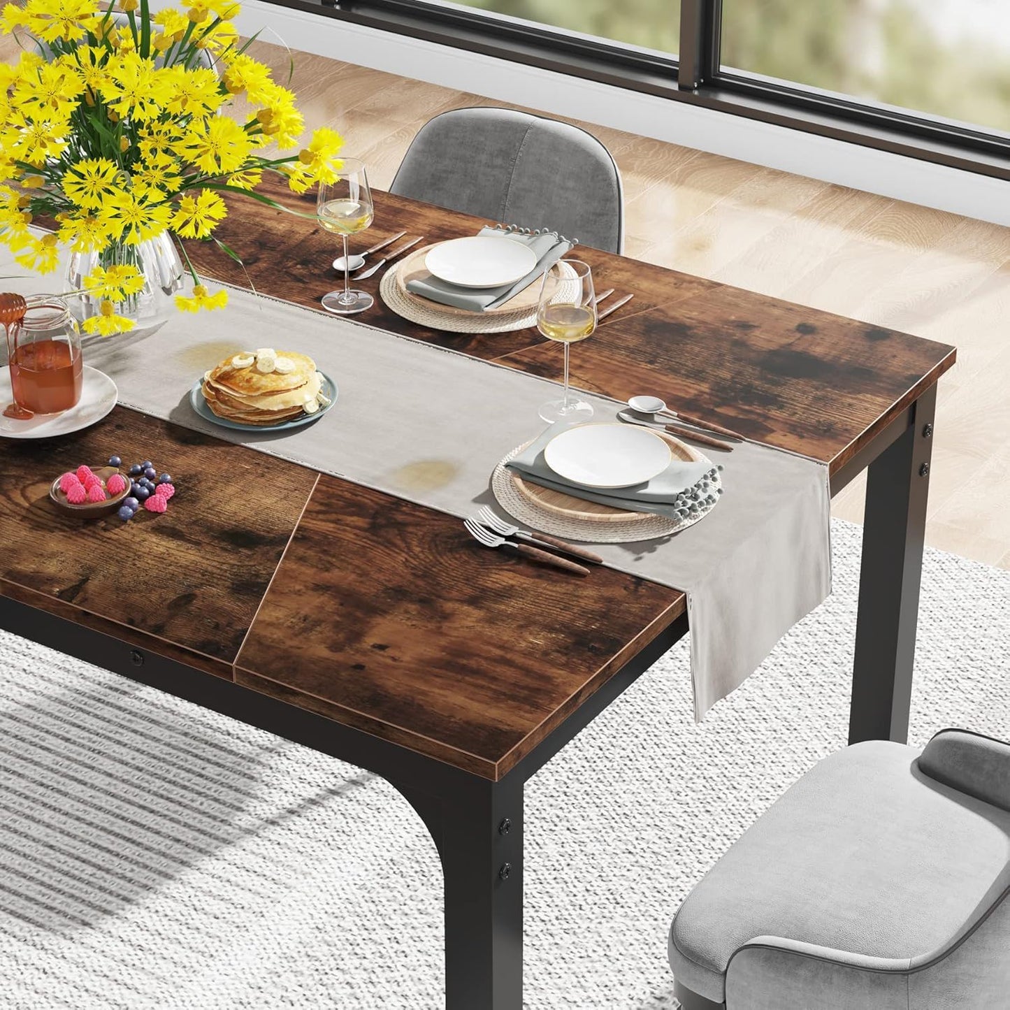 Rectangular dining table in brown wood with black legs, HouseOfZazla, set with plates, yellow floral centerpiece on Tampa Home & Garden Store