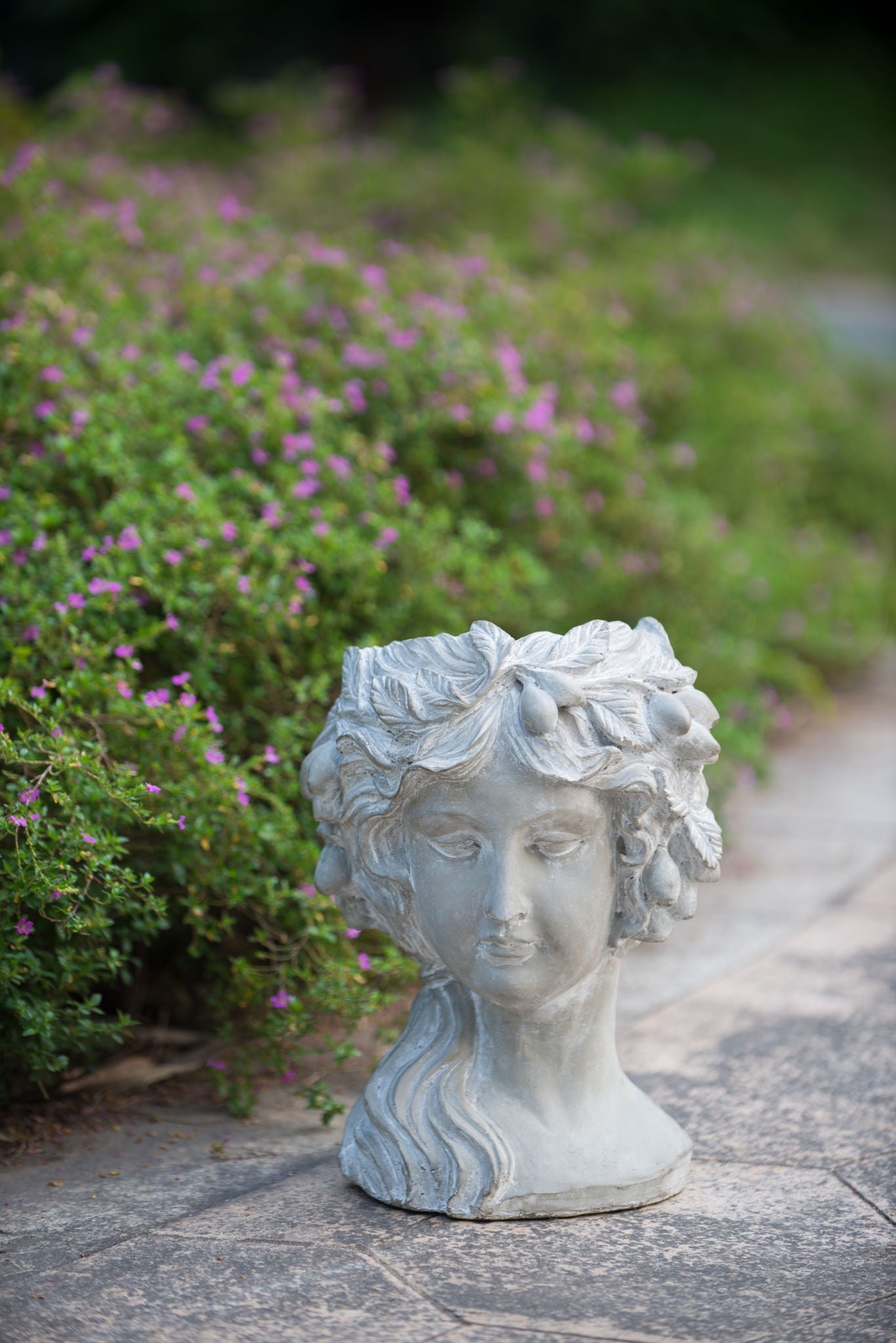Gray cement bust wall planter, 8-in, HouseOfZazla, classical garden statue amid purple flowers on Tampa Home & Garden Store