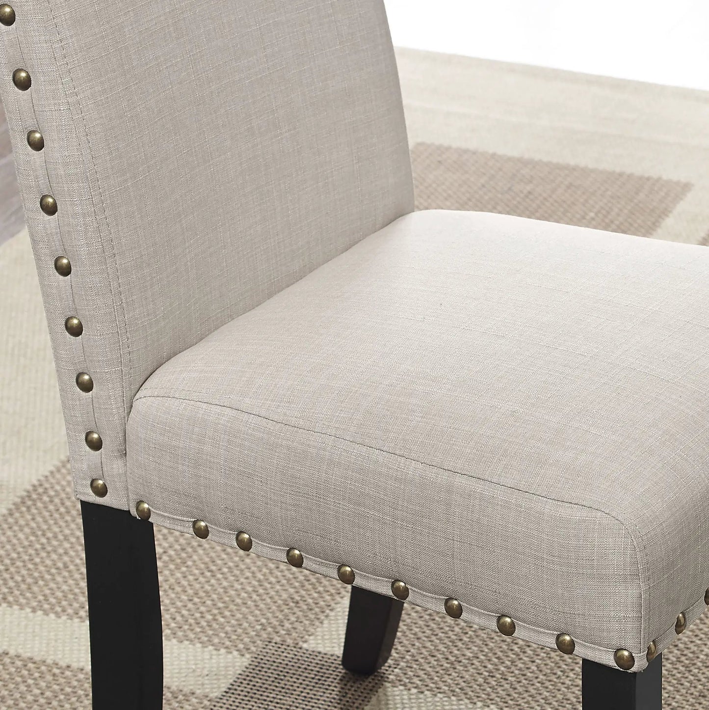 Mytzi 5 Piece Dining Set tan upholstery chair close-up with nailhead trim and black legs on Tampa Home & Garden Store
