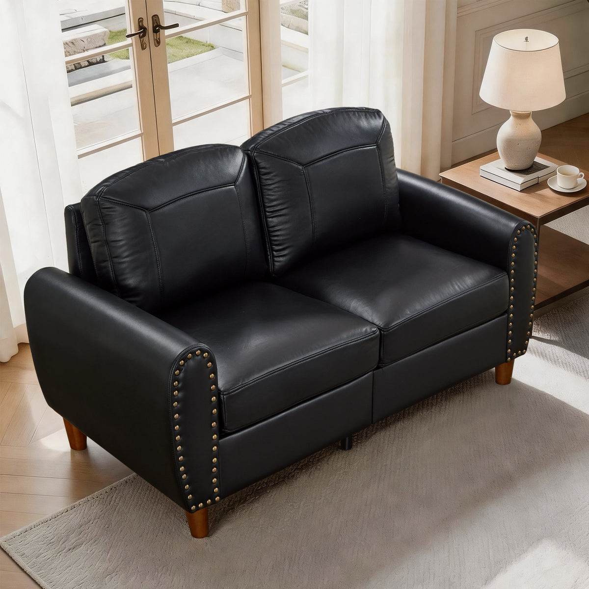 Faux leather loveseat in black with nailhead trim and wood legs on Tampa Home & Garden Store