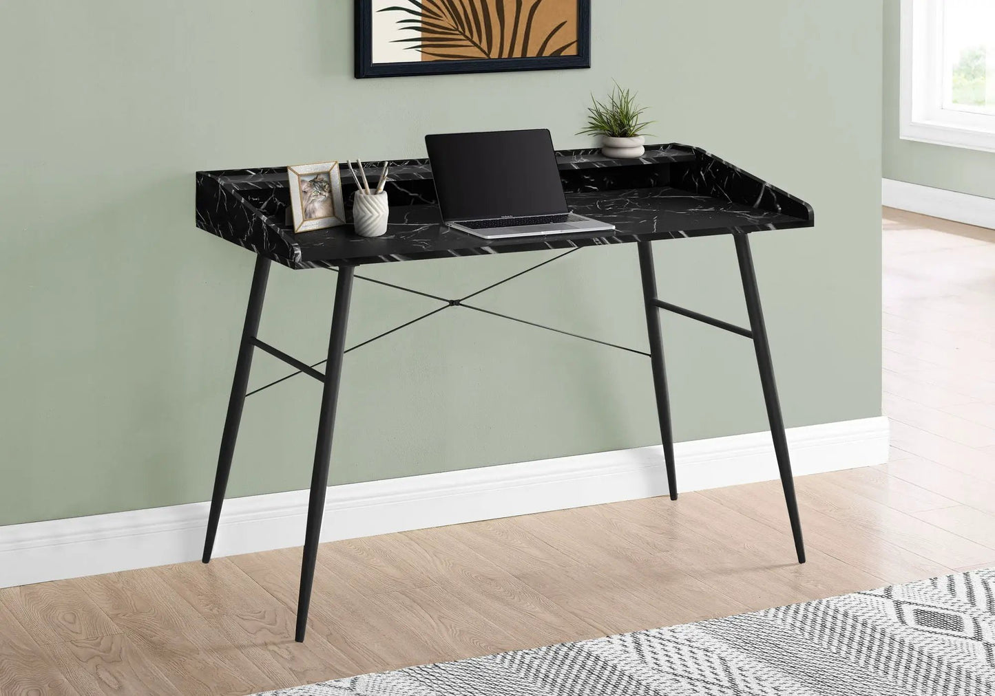 Computer desk with black marble top and slender metal legs, laptop, plant, and framed cat photo on Tampa Home & Garden Store