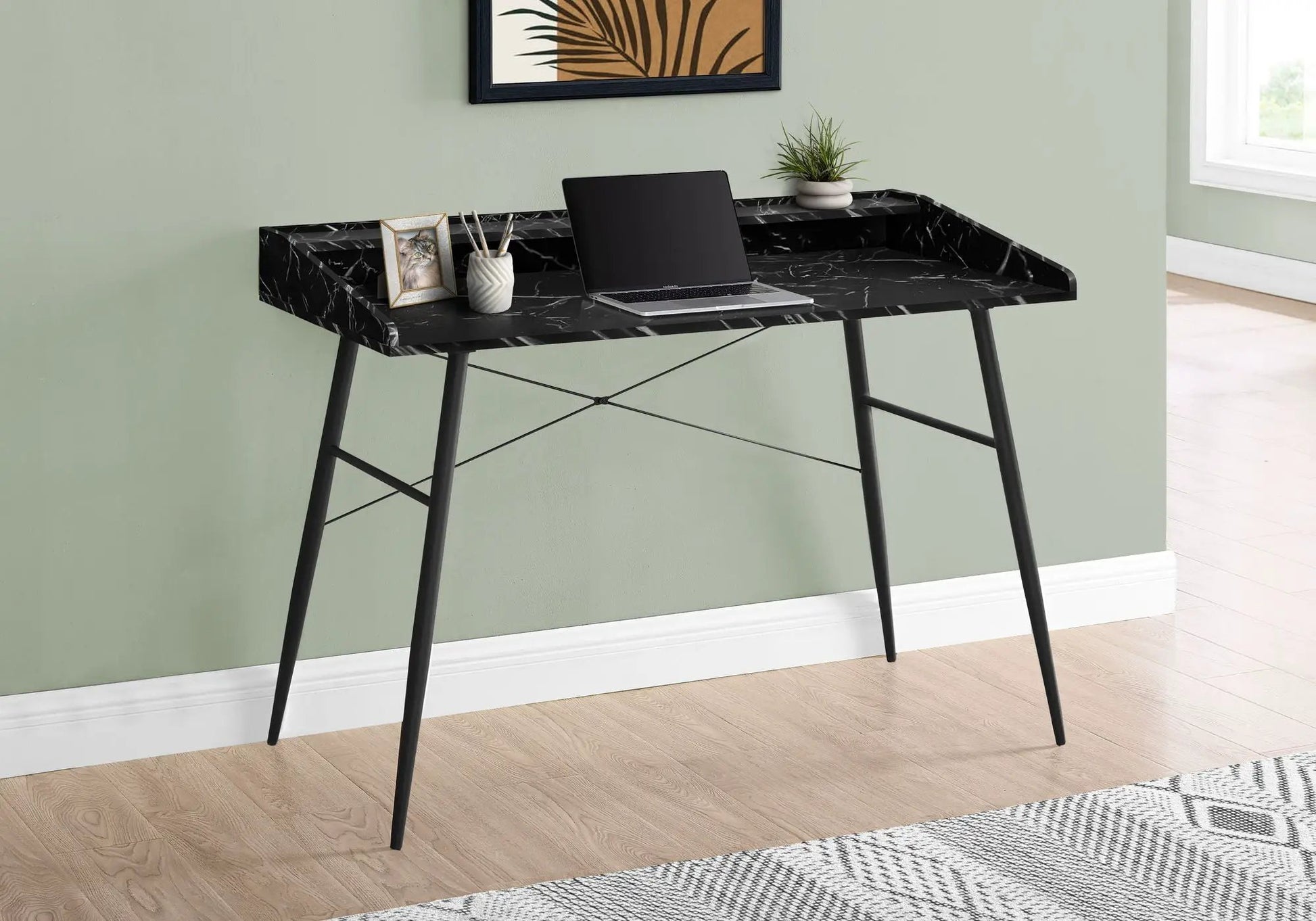 Computer desk with black marble top and slender metal legs, laptop, plant, and framed cat photo on Tampa Home & Garden Store
