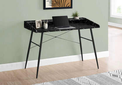Computer desk with black marble top and slender metal legs, laptop, plant, and framed cat photo on Tampa Home & Garden Store