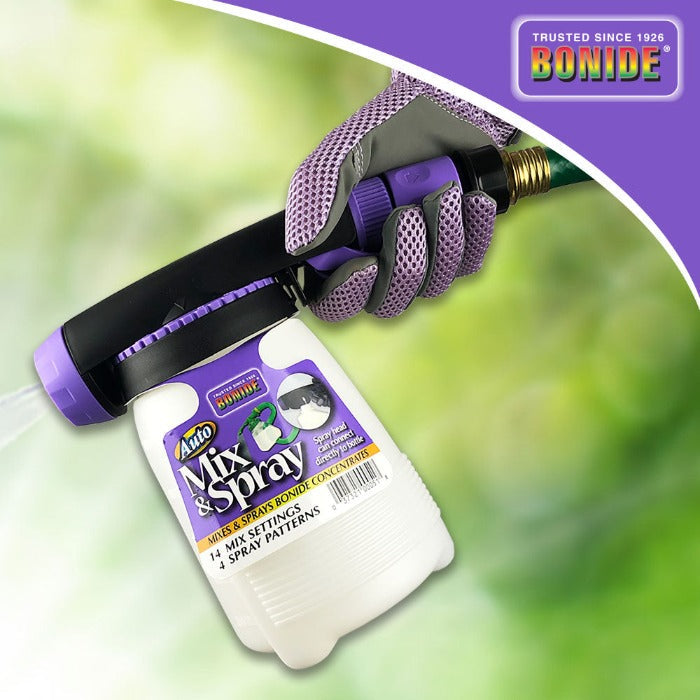 Bonide Auto Mix Hose End Sprayer white bottle with purple label and nozzle, held by gloved hand on Tampa Home & Garden Store