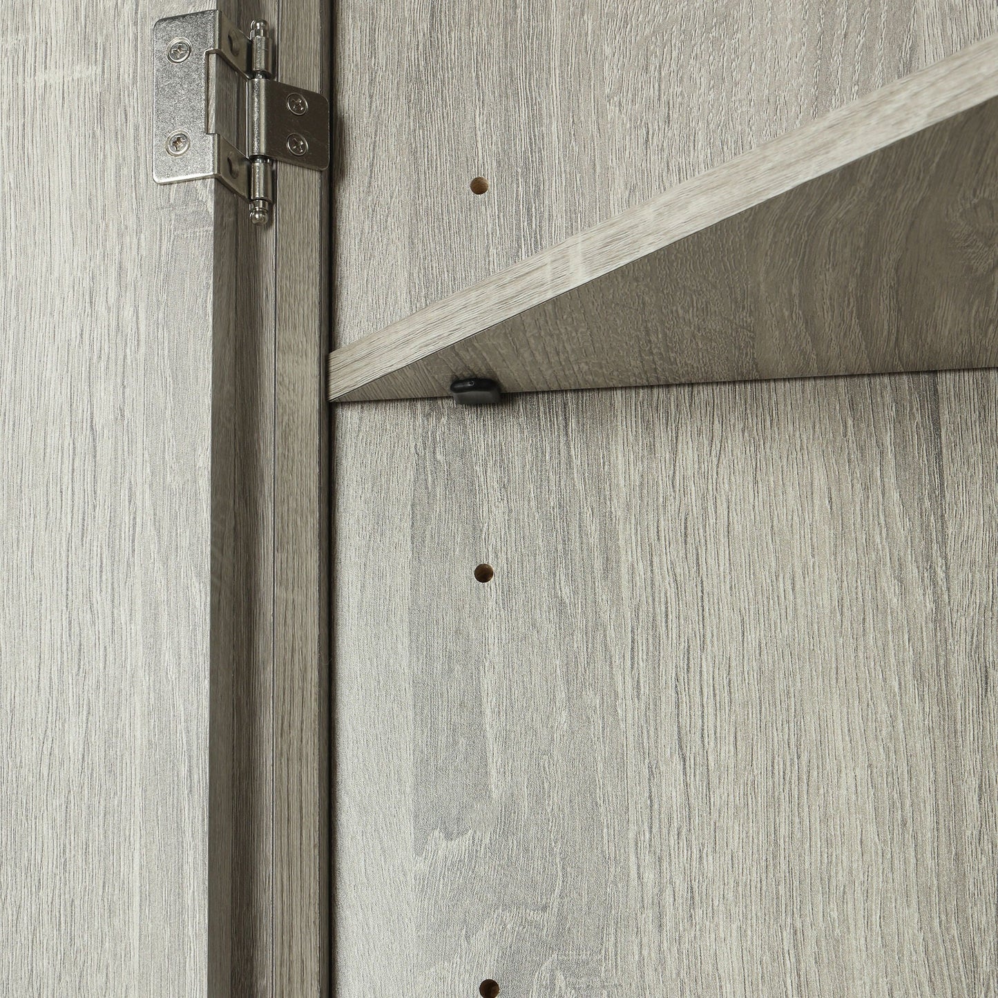 Linen cabinet door hinge close-up on gray wood grain panel with exposed screws on Tampa Home & Garden Store