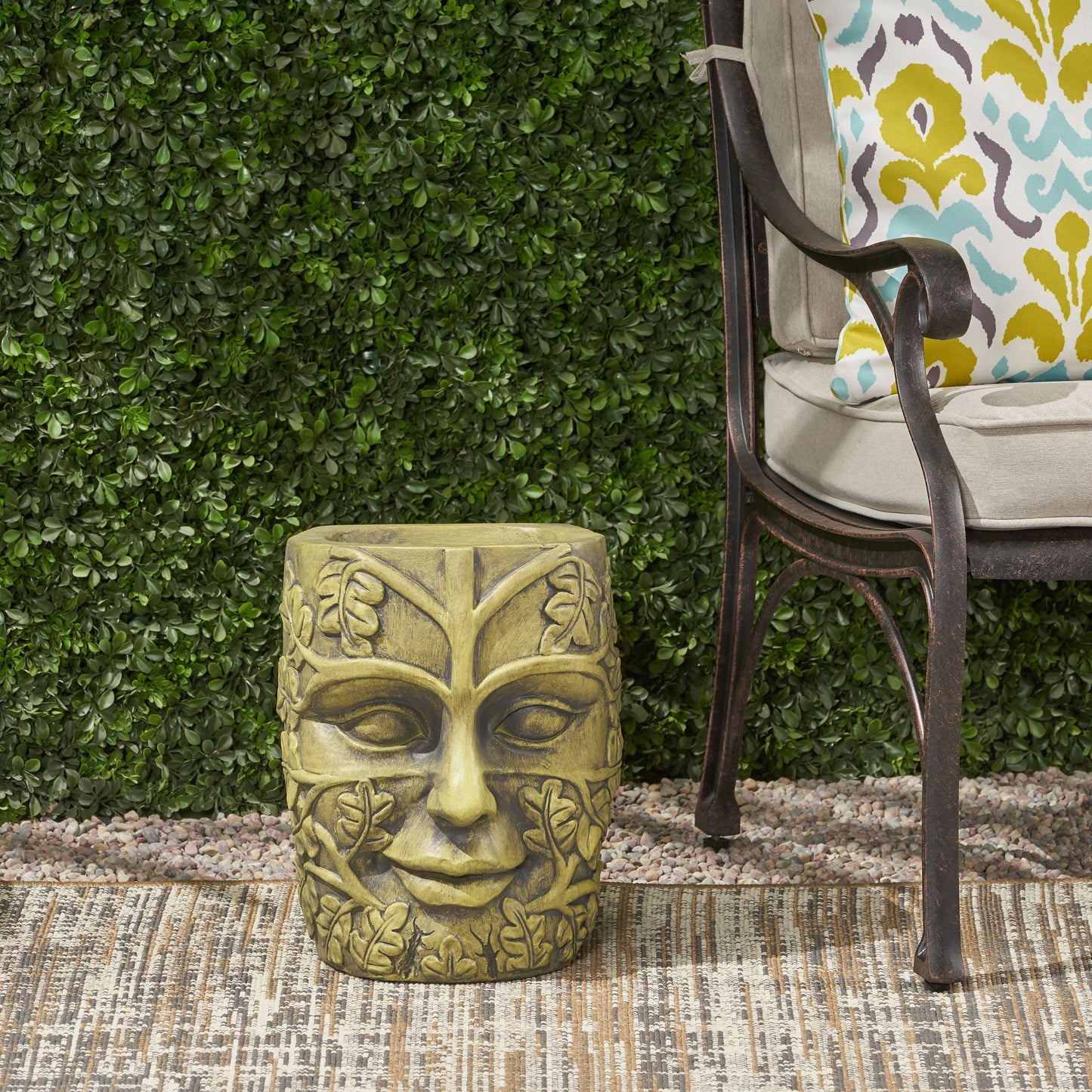 Garden urn planter in tan stone finish with carved leaf and face motif on Tampa Home & Garden Store