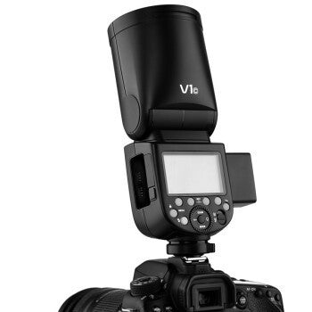 Sell My Stuff V1 external flash mounted on a black DSLR camera with LCD panel and control dial on Tampa Home & Garden Store
