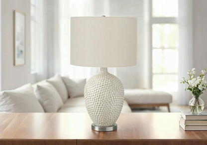 Ceramic table lamp in cream with a textured scale-pattern base and beige fabric shade by Unique Piece Furniture on Tampa Home & Garden Store