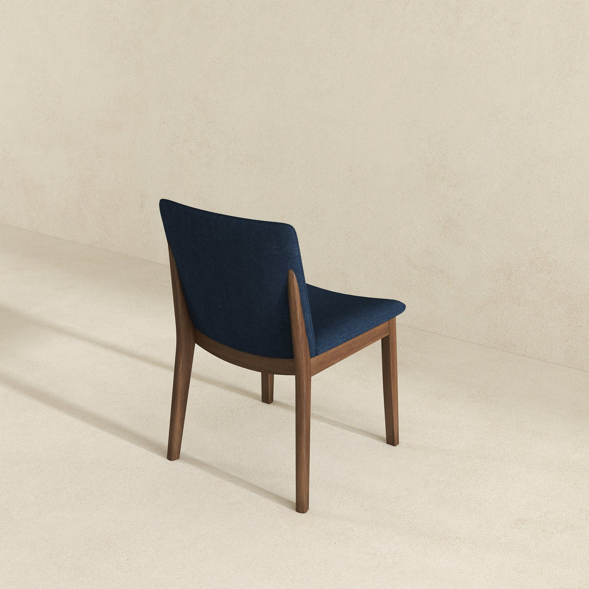 Mid-Century Modern solid wood dining chair with navy fabric upholstery and angled legs on Tampa Home & Garden Store