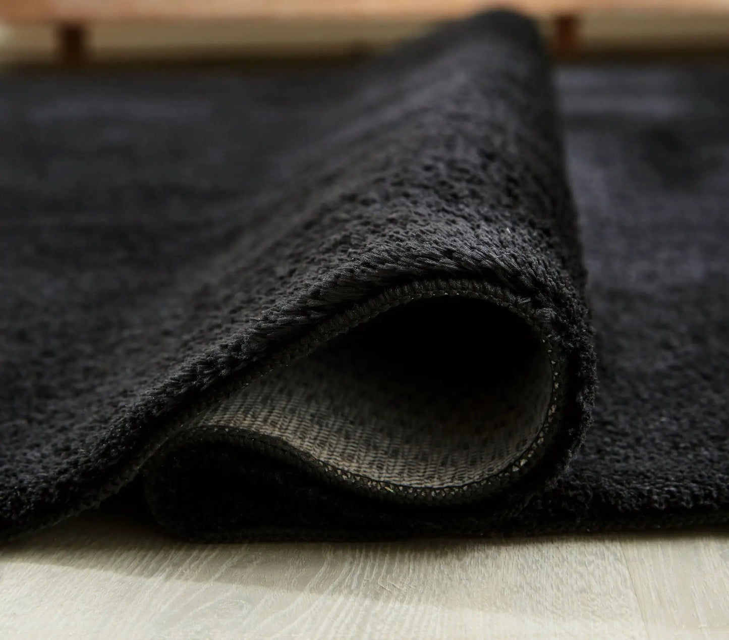 Anaben rug charcoal black washable rug with plush pile and stitched edge folded corner on Tampa Home & Garden Store