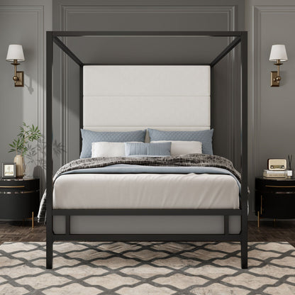 Canopy bed with tall beige upholstered headboard and four-poster frame in dark metal, blue-gray pillows on Tampa Home & Garden Store