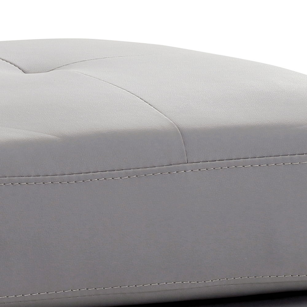 Upholstered ottoman in light gray faux leather with stitched detailing on Tampa Home & Garden Store