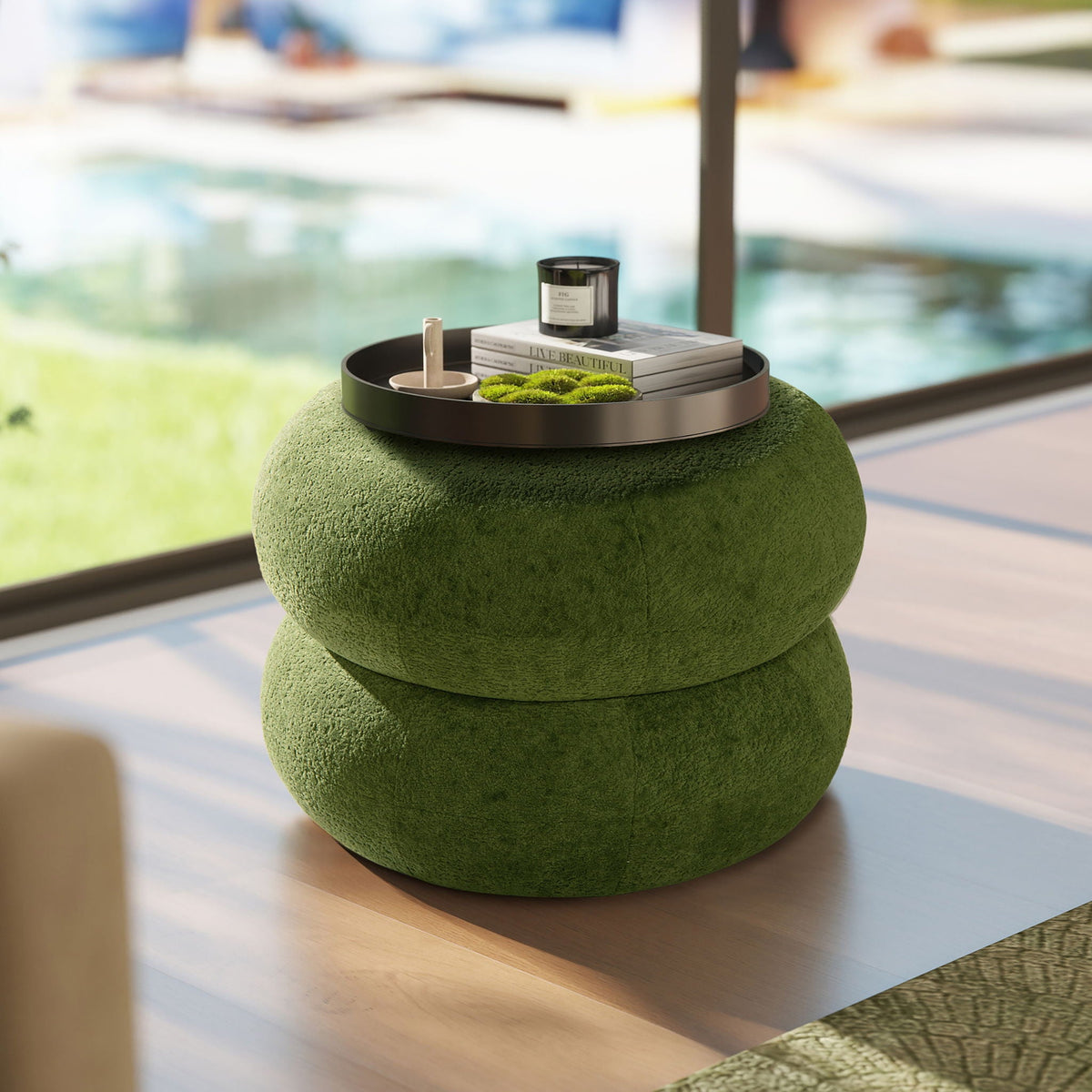 Dark green low round ottoman with stacked pouf design and tray holding candle and books on Tampa Home & Garden Store