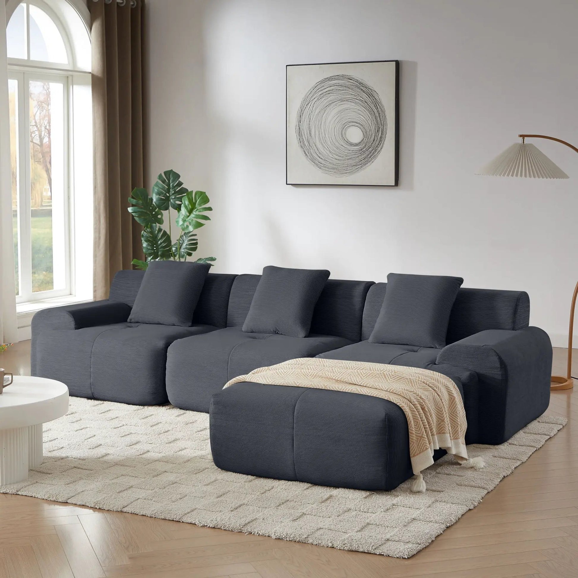 L-shaped modular sectional sofa with movable ottoman in charcoal gray fabric on Tampa Home & Garden Store