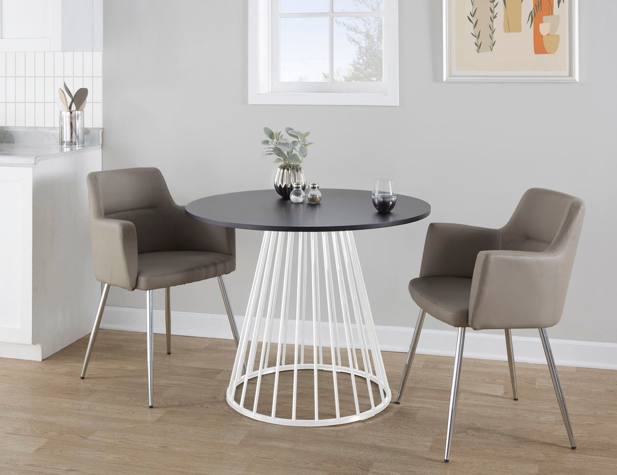 Contemporary dining table with black top and white metal base with two taupe chairs around on Tampa Home & Garden Store