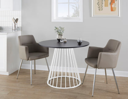 Contemporary dining table with black top and white metal base with two taupe chairs around on Tampa Home & Garden Store
