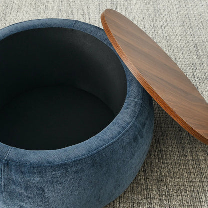 Round blue denim storage ottoman with black interior next to a wood end table top on Tampa Home & Garden Store