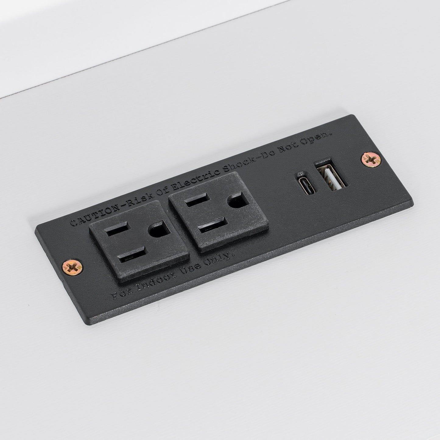 Black electrical outlet strip with USB ports and safety screws on white surface on Tampa Home & Garden Store