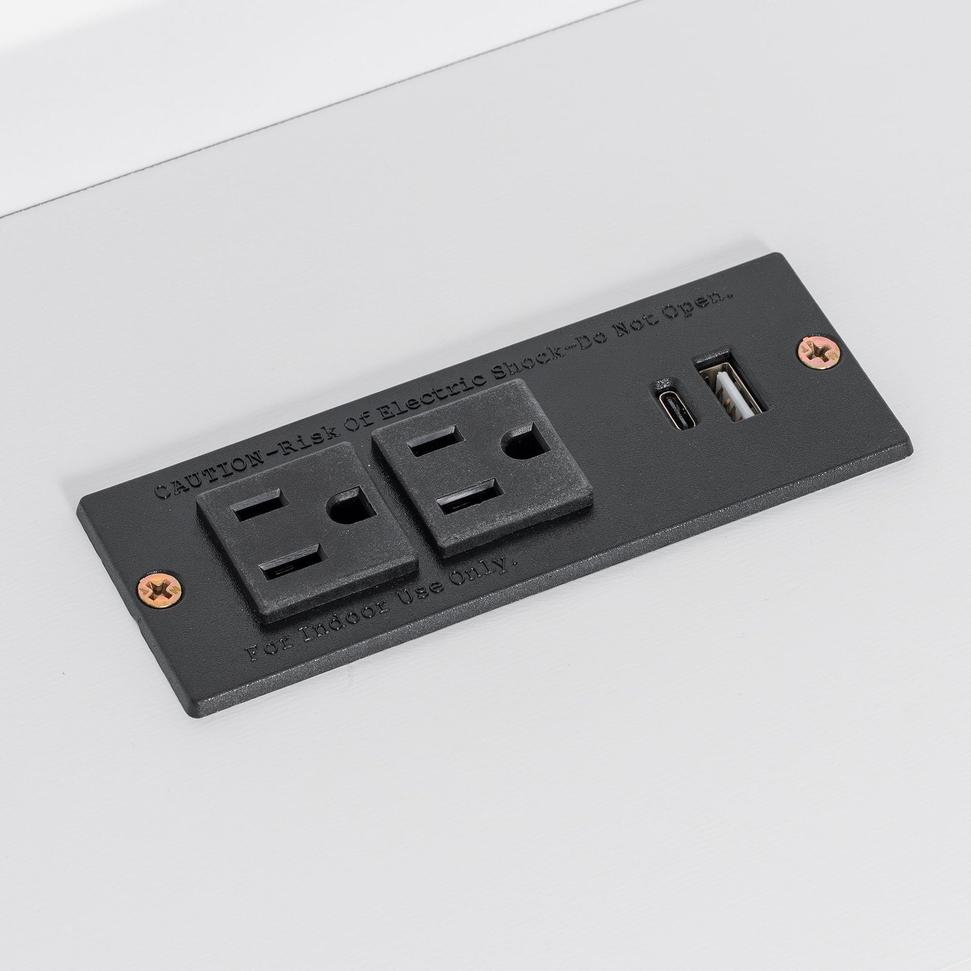 Black electrical outlet strip with USB ports and safety screws on white surface on Tampa Home & Garden Store