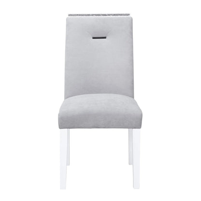 Ariya dining chair in light gray upholstery with crystal trim at the back and white legs on Tampa Home & Garden Store