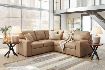 Bandon Sectional by Unique Piece Furniture in tan leather with neutral pillows on Tampa Home & Garden Store