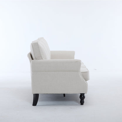 Beige fabric rolled-arm chair with nailhead trim and dark wood legs on Tampa Home & Garden Store