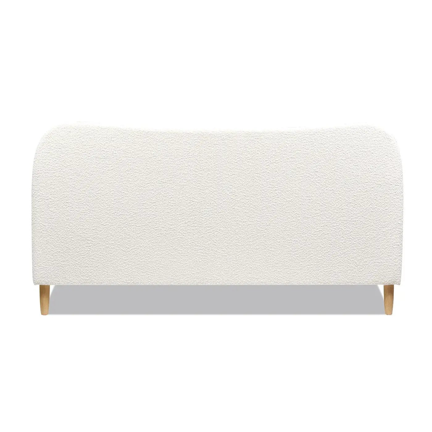 Roman curved headboard upholstered platform bed in cream boucle fabric with light wood legs on Tampa Home & Garden Store