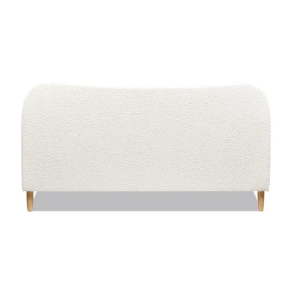 Roman curved headboard upholstered platform bed in cream boucle fabric with light wood legs on Tampa Home & Garden Store