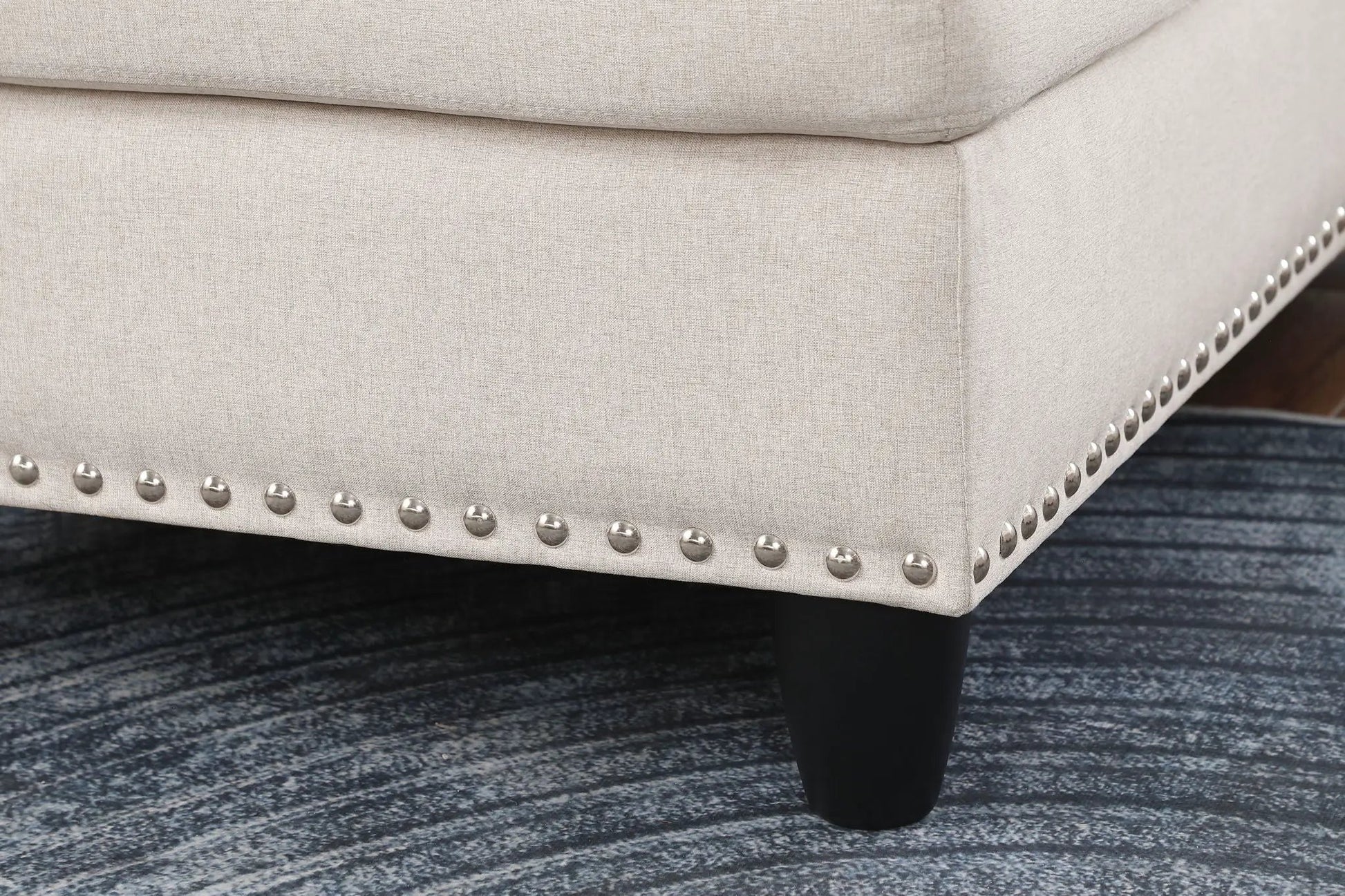 Alger wide left-hand facing beige sofa in linen fabric with silver nailhead trim on dark leg on Tampa Home & Garden Store