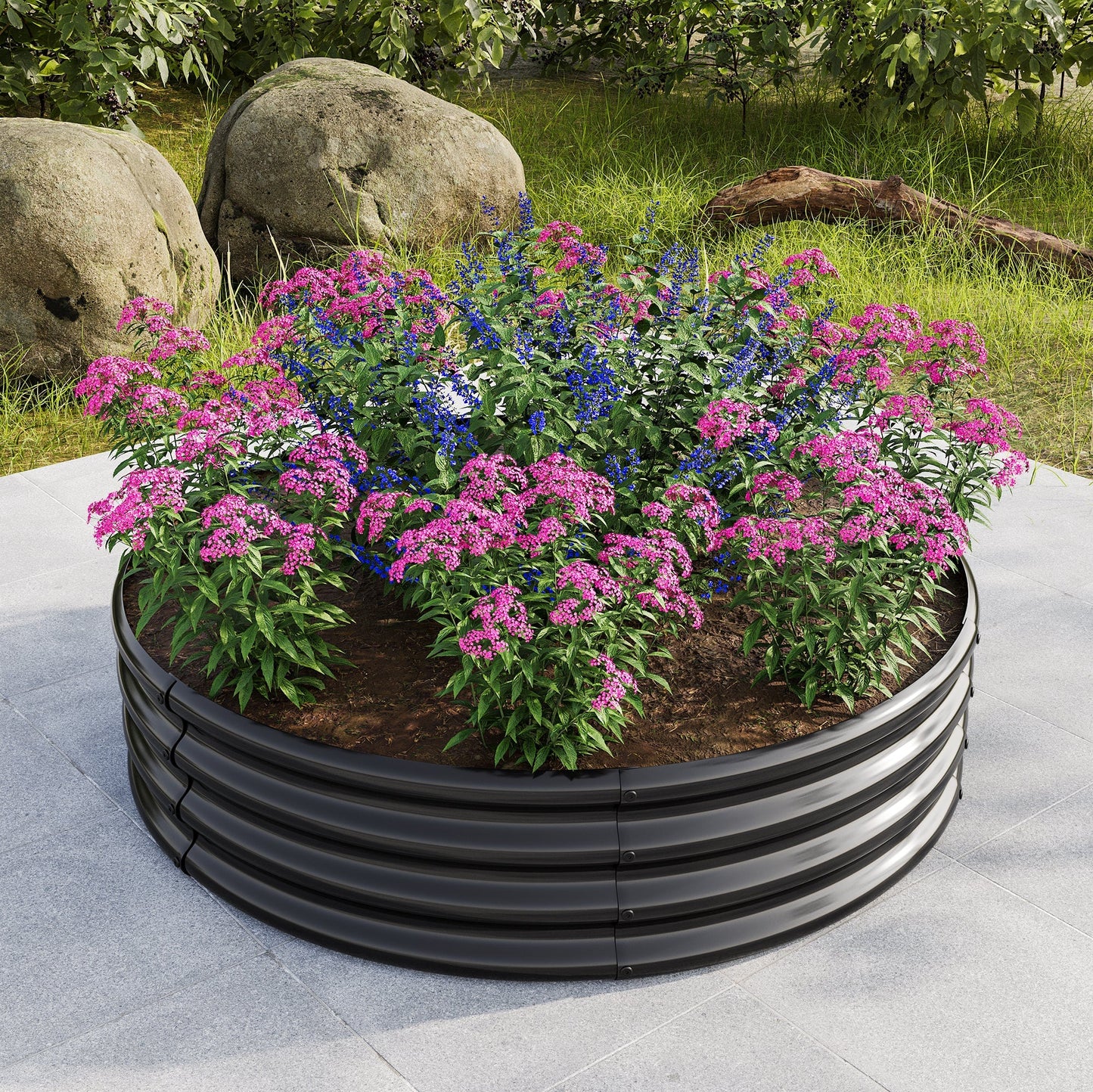 Round metal raised garden bed planter filled with pink and blue flowers on a patio on Tampa Home & Garden Store