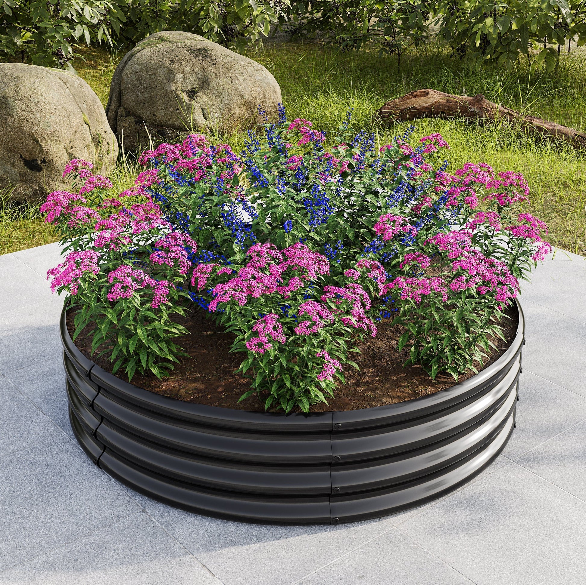 Round metal raised garden bed planter filled with pink and blue flowers on a patio on Tampa Home & Garden Store