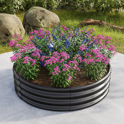 Round metal raised garden bed planter filled with pink and blue flowers on a patio on Tampa Home & Garden Store