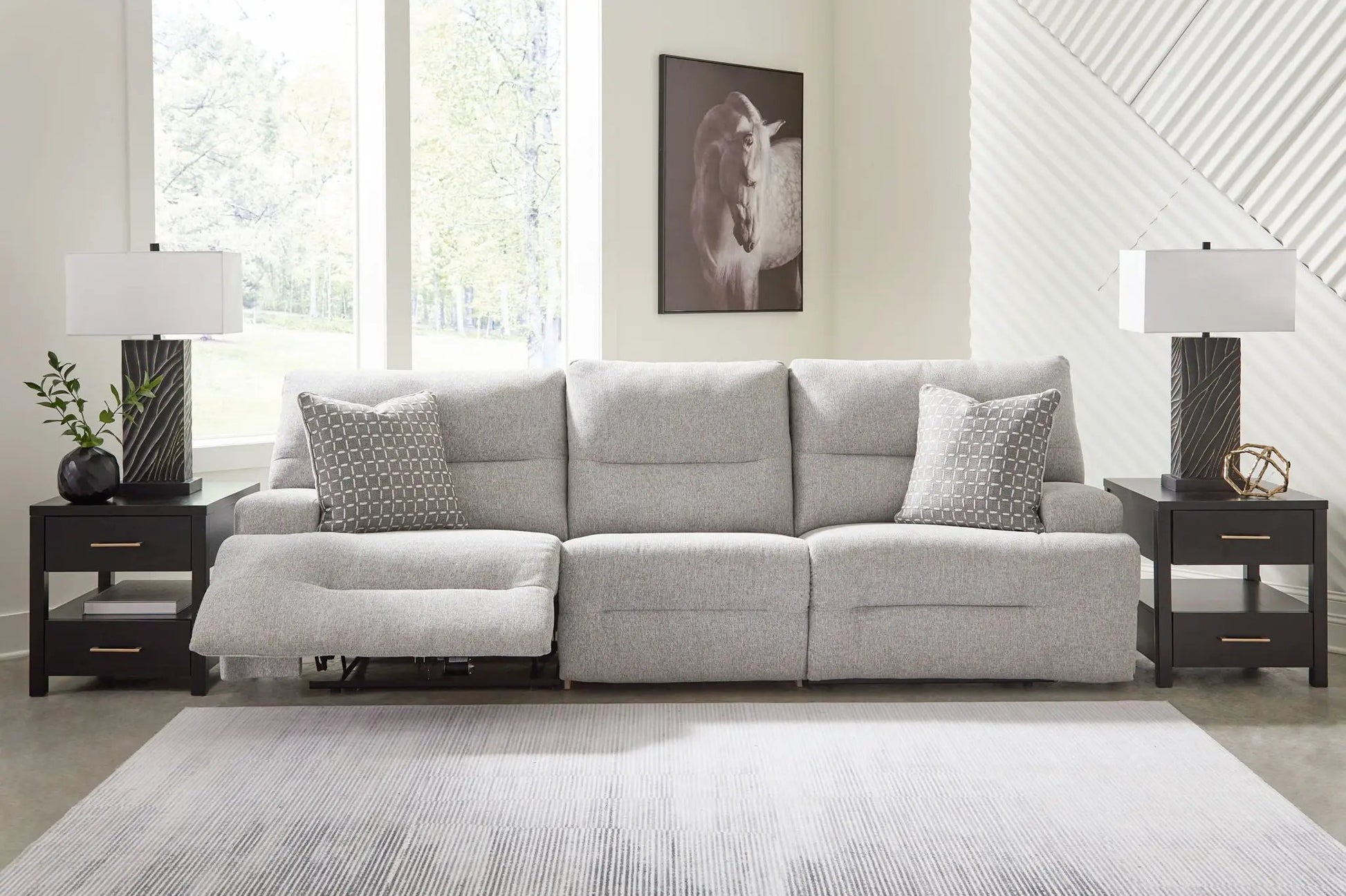 Acklen Place reclining sectional in light gray fabric with gray patterned pillows on Tampa Home & Garden Store